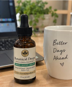 A bottle on a workday desk next to a computer and coffee mug — wellness that has to fit real days